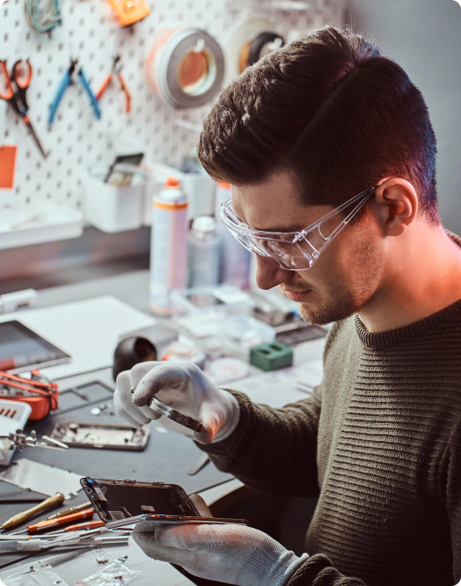 Technician repairing a damaged smartphone